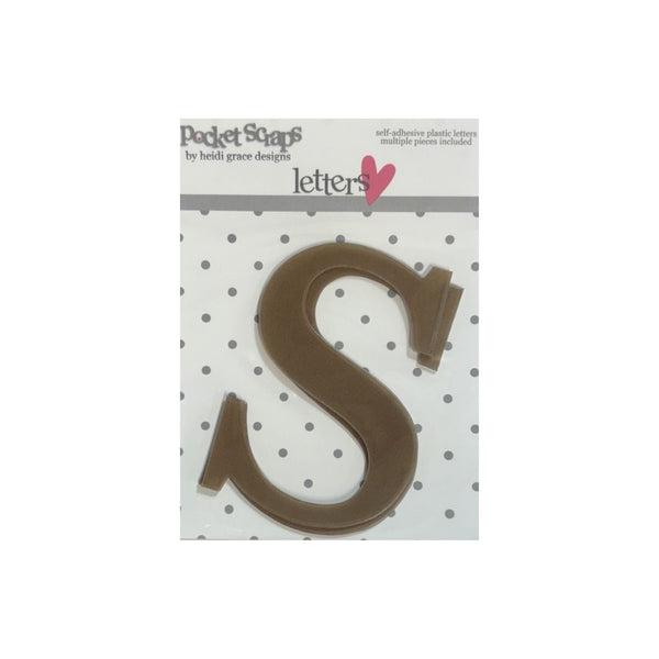 A packaged letter 'S' plastic craft cutout from Pocket Scaps by Heidi Grace Designs, shown on a white background with a polka dot pattern.