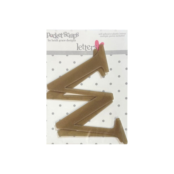 A packaged letter 'w' plastic craft cutout from Pocket Scaps by Heidi Grace Designs, shown on a white background with a polka dot pattern.