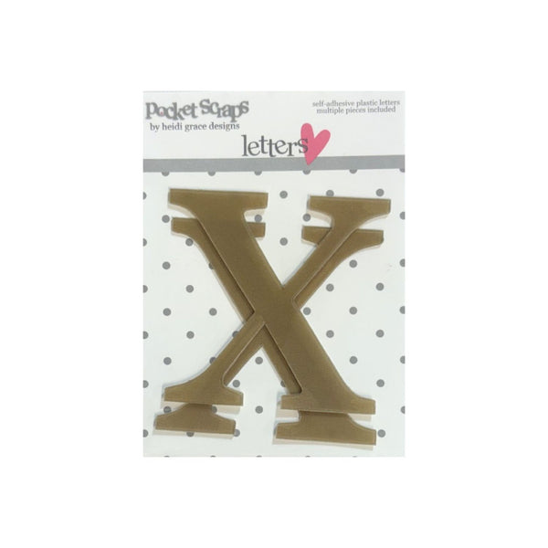 A brown plastic letter 'X'  from Pocket Songs by Beth Grace Design, shown on its white and gray polka dot backing card against a white background.