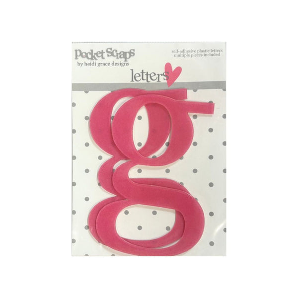 A package of bright pink felt letters 'g' by Heidi Grace Designs, displayed on a white card with gray polka dots.