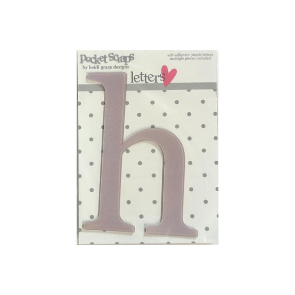 A single lowercase letter 'h' plastic craft letter by Pocket Scaps, shown in its retail packaging. The letter is a dusty mauve-pink color, mounted on a white backing card with gray polka dots and a pink heart logo.