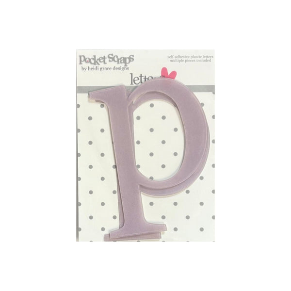 A lavender plastic letter 'P' adhesive letter from Pocket Scaps by Heidi Grace Designs, shown on its original white and gray polka dot backing card.