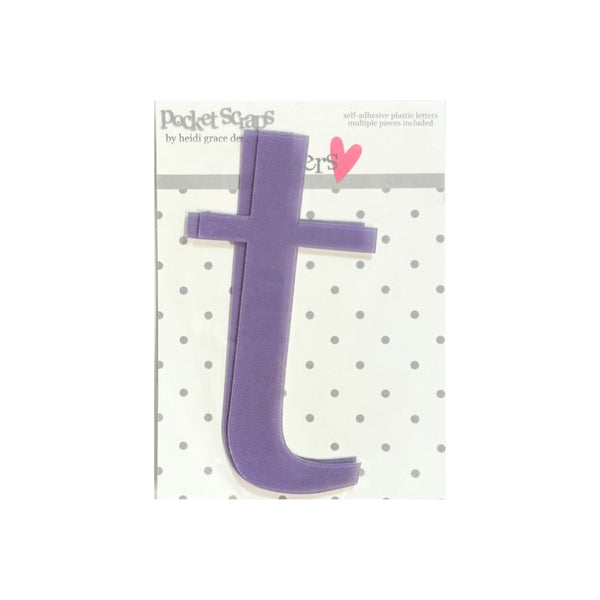 A purple foam letter 't' cutout from a set of pocket scarves by Heidi Grace Design, shown on its white backing card with gray polka dots and a pink heart.
