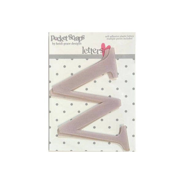 A packaged letter 'W' acrylic adhesive letter from Pocket Scaps by Heidi Grace Designs, shown on its white polka-dot backing card.