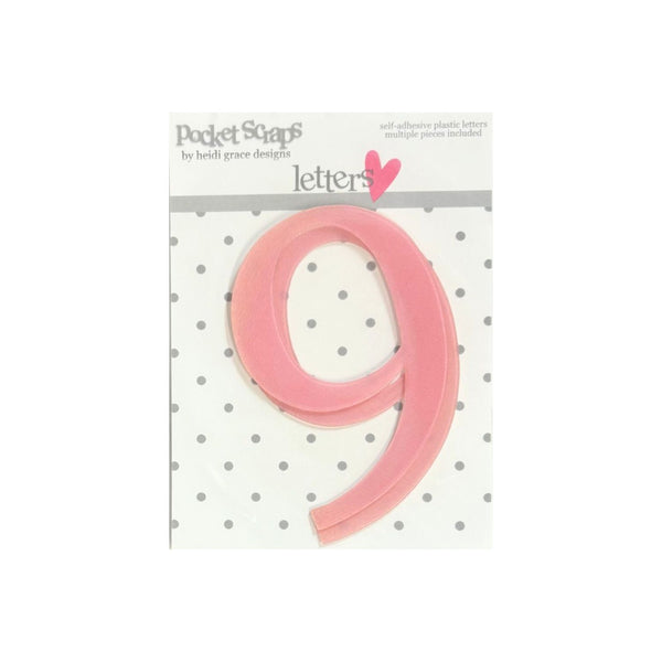 A pink plastic number 'nine' die-cut sticker from Pocket Scaps by Beth Grace Designs, shown on its white backing card with a gray polka dot pattern.