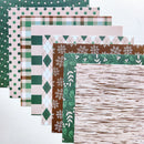 A fan arrangement of patterned paper sheets in holiday and neutral tones, including green polka dots, plaid, argyle, snowflakes, holly, and a birch-wood texture on a white background.