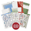 A set of decorative paper sheets and embellishment sheets arranged on a white background, featuring holiday designs in blue, red, green, and gray. A red circular badge at the bottom reads 'INCLUDES 2 OF EACH DESIGN'.