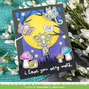 A handmade greeting card featuring a whimsical moth-themed illustration, displayed on a textured teal surface with white flowers. The card has a black border and shows three colorful butterflies, a large yellow moon, a snail under a purple mushroom, and the text 'i love you very moth'.