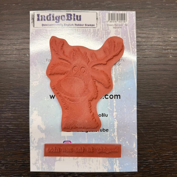 Red rubber stamp with a dog design on IndigoBlu packaging.