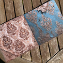 Two patterned rugs on a wooden surface