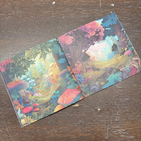 Two colorful greeting cards with nature-themed designs on a wooden surface.