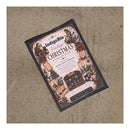 A flat-lay photograph of a book titled 'IndigoBlu Vintage Christmas Collection' on a textured beige burlap background.