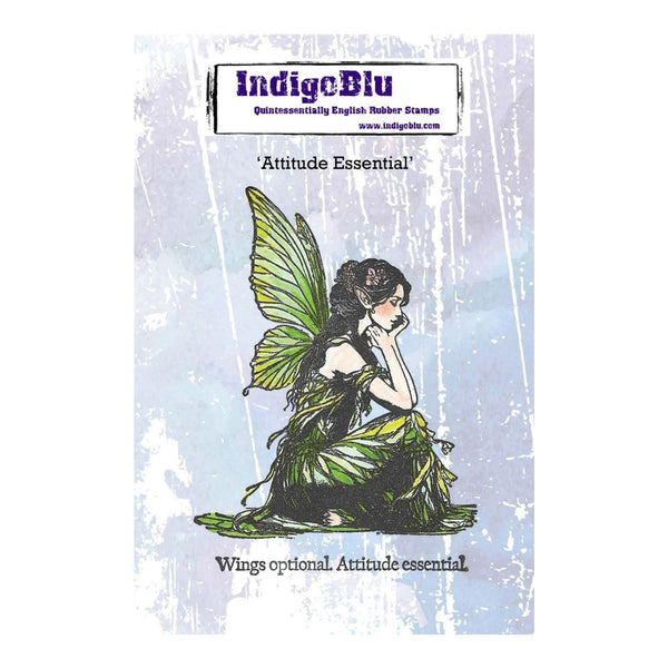 IndigeBlu 'Attitude Essential' rubber stamp featuring an illustration of a fairy with green wings and leafy green clothing, shown on a light blue textured background with the brand logo at the top.