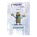IndigeBlu 'Surprise!' rubber stamp design featuring a colorful, striped monster with raised arms on a distressed light blue background with white text.