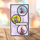A handmade greeting card featuring three circular illustrations of cartoon mice in holiday poses, with a central banner reading 'HAY-YOUR DAYS BE MERRY AND NICE'. The card is displayed upright on a wooden surface with a blurred bokeh background.