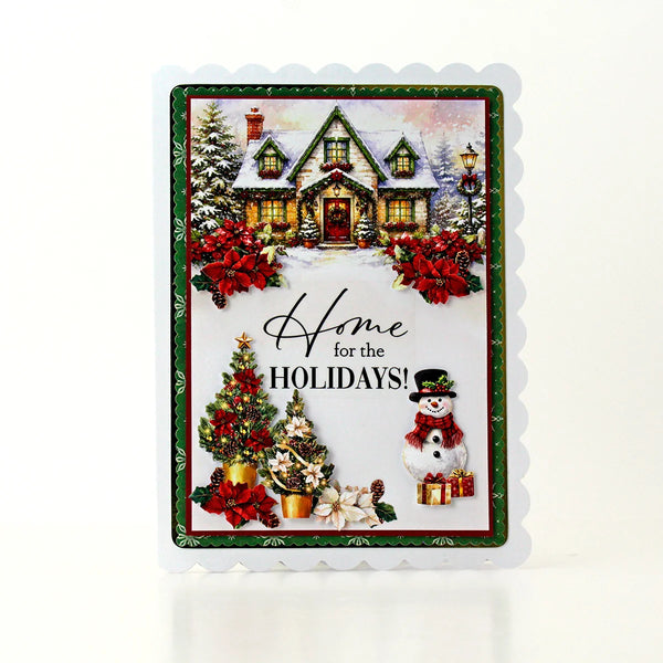 A scalloped holiday greeting card featuring a snowy cottage, poinsettias, a decorated Christmas tree, a snowman, and the text 'Home for the HOLIDAYS!' on a white background.