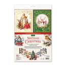 A packaged paper craft set labeled 'Nostalgic Christmas' with two illustrated panels at the top showing a lantern and a snowy deer scene, plus a lower section showing included decorative elements and small printed pieces. The package is photographed on a plain white background.