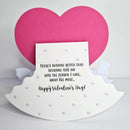 A handmade Valentine's Day card featuring a white scalloped base with small pink hearts, a central white card with black text reading 'There's nothing better than spending this day with the person I care about the most.