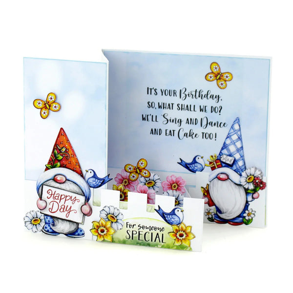 A handmade birthday card set featuring two 3D gnomes, blue birds, yellow flowers, and a watercolor background. One card is shown closed with a 'Happy Day!' sign, and the other is open with a birthday message, displayed on a clean white background.
