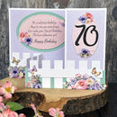 70th birthday card with floral decorations on a wooden surface