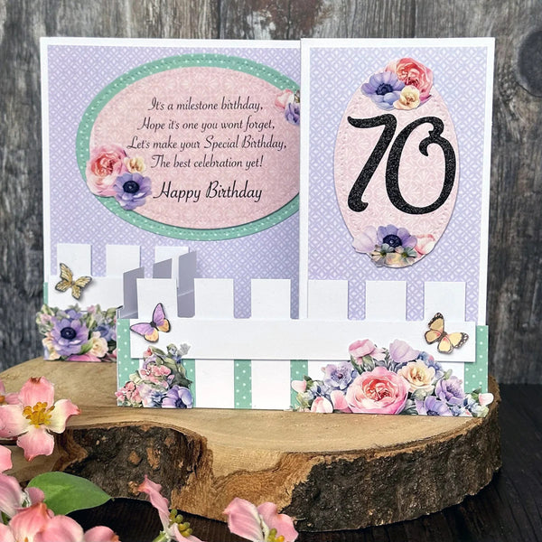 70th birthday card with floral decorations on a wooden surface
