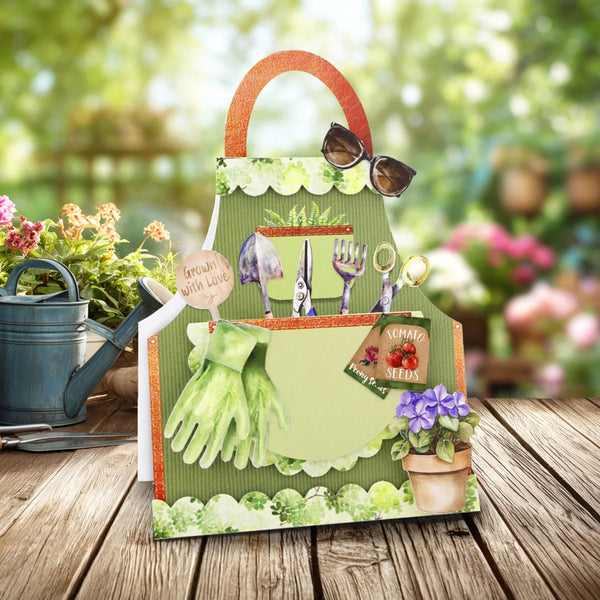 Gardening-themed gift bag with tools and plants on a wooden surface