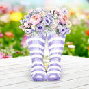 Purple and white striped socks with floral decorations on a wooden surface.