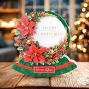 Decorative Christmas card with poinsettias and mistletoe on a wooden surface.