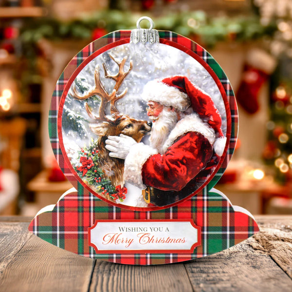 Christmas ornament with Santa Claus and reindeer on a plaid background