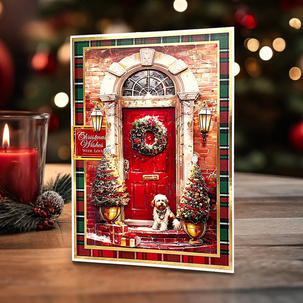 Christmas-themed greeting card with a red door, wreath, and dog on a wooden surface with a candle and decorations.