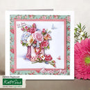 A handmade greeting card with a floral and bouquet design, displayed next to a large pink gerbera daisy. The card features a pink border, a green floral patterned background, and a central illustration of a pink checkered vase filled with pink, red, and blue flowers, with the text 'On You' and 'Special Day'.
