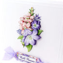 A close-up of a decorative card featuring a raised floral arrangement of pink and purple bell flowers with green leaves, plus a small ribbon label reading 'Bell Flower' on a white card background.