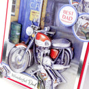 A close-up of a 3D card featuring a detailed illustration of a red and silver motorcycle parked in front of a blue garage door. The card includes layered paper elements, including a circular badge that reads 'BEST DAD' and the text 'Wonderful Dad' at the bottom.