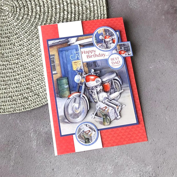 Greeting card with motorcycle illustration and 'Happy Birthday' text on a textured surface