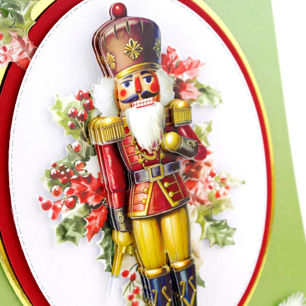 Colorful nutcracker toy with holly leaves and berries on a decorative card.