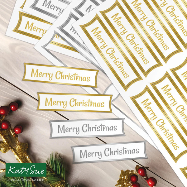 Merry Christmas labels on a wooden surface with decorative elements.