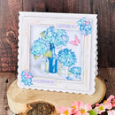 Decorative card with blue flowers and a blue bottle on a wooden surface