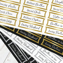 Collection of decorative name labels with phrases like 'Darling Husband' on a white surface.