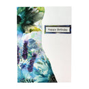 A vertical greeting card with a watercolor floral design in shades of blue, purple, green, and white on the left side, and a plain white right side featuring a small rectangular label that reads 'Happy Birthday'.