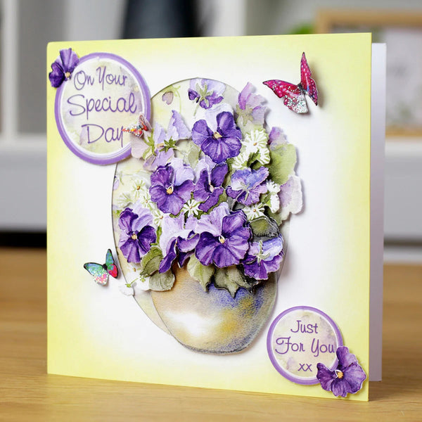 Greeting card with floral design and butterflies on a wooden surface
