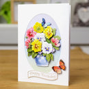 Greeting card with colorful flowers and butterflies on a wooden surface