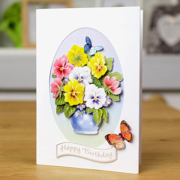Greeting card with colorful flowers and butterflies on a wooden surface