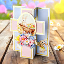 Easter-themed card with bunnies and flowers on a wooden surface with blurred colorful background
