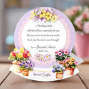 Greeting card with floral design and birthday message for a special sister on a wooden surface.