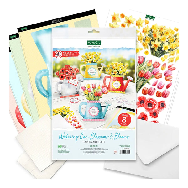 Kettle Sips 'Wintering Can Blossoms & Blooms' card making kit, showing the main package with floral watercolor illustrations, surrounded by included craft sheets and white envelopes on a clean white background.