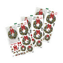 Four sheets of Christmas door wreath decals arranged on a white background, featuring green wreaths with red bows, pinecones, ornaments, and holiday decorations.