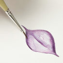 A close-up of a watercolor painting of a purple lotus flower petal, with a fine paintbrush touching the edge of the painted area on a clean white background.