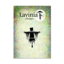 A rectangular card or package front for Lavinia Stamps featuring a black silhouette of a hooded figure with a top hat and long ragged cloak, set against a mottled pastel background with green, yellow, and lavender tones. The Lavinia Stamps logo appears at the top, and three website watermarks are visible across the center.