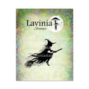 A rectangular card or packaging insert for Lavinia Stamps, featuring a black silhouette of a witch riding a broomstick against a textured pastel background with green, yellow, and lavender tones. The Lavinia Stamps logo appears at the top, and repeated website watermarks are visible across the center.