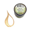 A small round jar labeled 'Metal Pigment Antique Gold' next to a textured gold pigment smear on a plain white background.